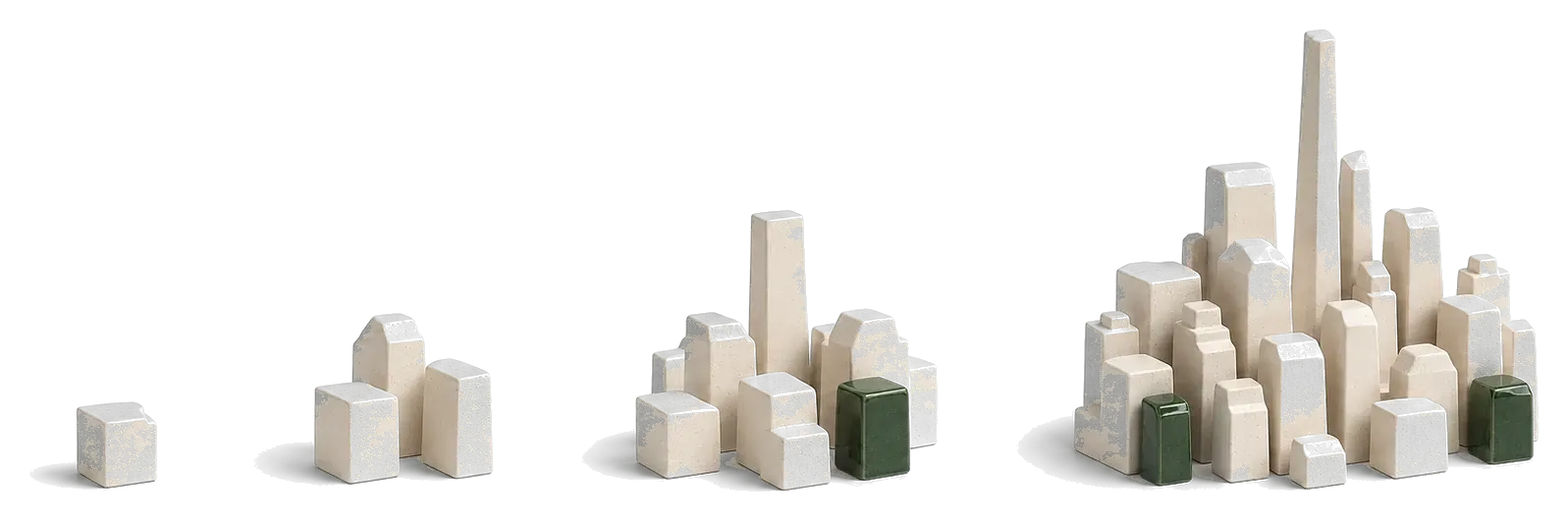 Four plaster massing models growing from a single block into a dense settlement
